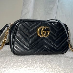 Black crossbody Gucci purse.